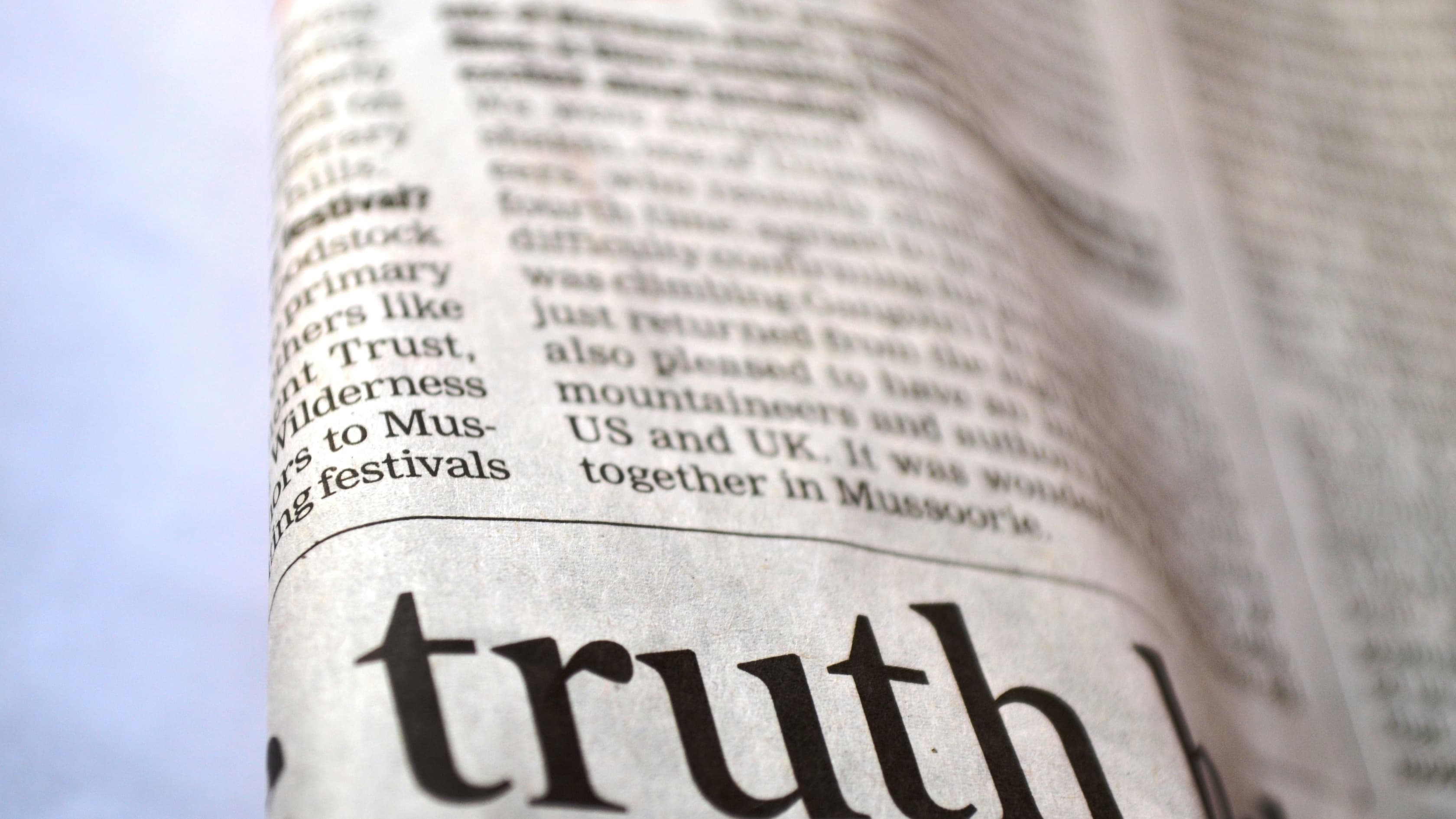 A close-up photograph of the word truth printed on a page